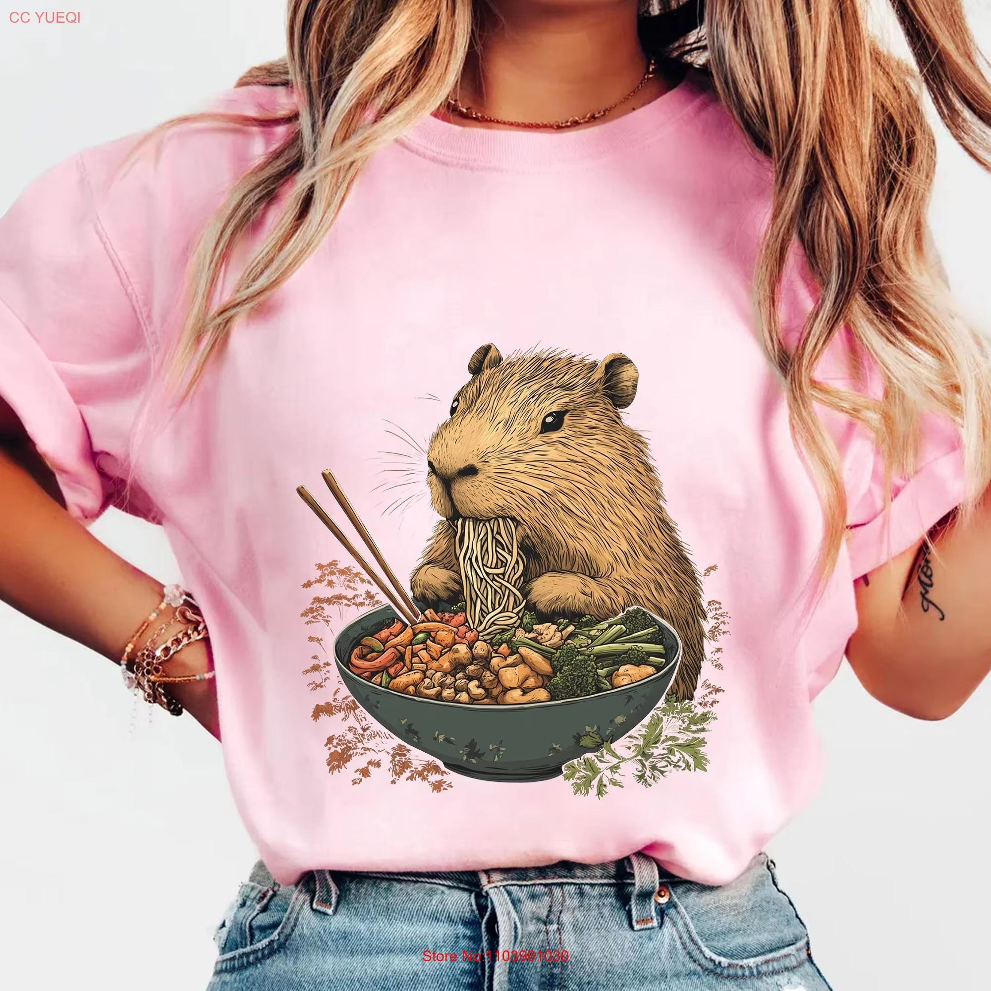 This is an animal food lover's shirt. This is a capybara, the goofy giant rodent, who is doing the munching, and she is eating ramen.