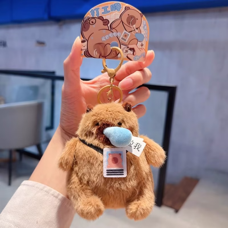 This dangling keychain in the shape of a capybara, with a plush body and bag that is wadded and fluffy, is a cool and whimsical accessory in the Wag Tail Soft Animal Keychain - Image 4